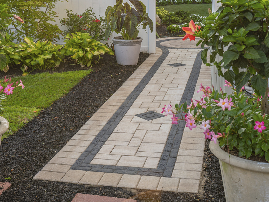 Affordable patio A flagstone walkway winds through an English cottage garden, passing beds bursting with hollyhocks and hydrangeas.