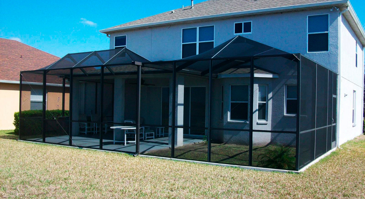 An outdoor seating area protected by high-quality mesh, providing a great example of how to clean lanai screens.