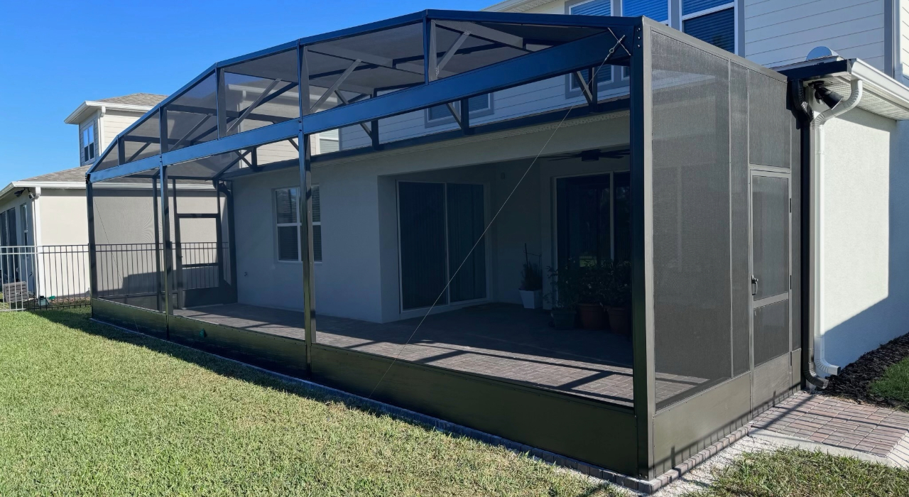 Clear views through a well-maintained mesh enclosure toward a lush landscape, highlighting how to clean pool screen enclosure effectively.