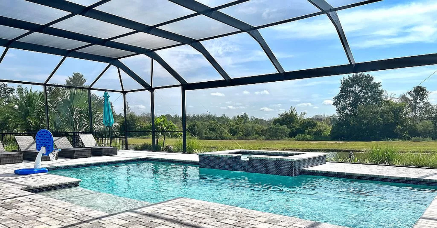 A large backyard pool protected from debris and pests by a mesh structure, explaining why do florida pools have cages.