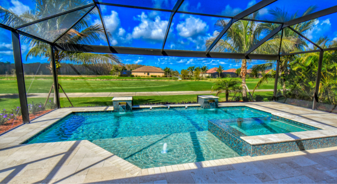 Comfortable outdoor living space under a protective screen dome, a clear example of why do florida pools have cages.