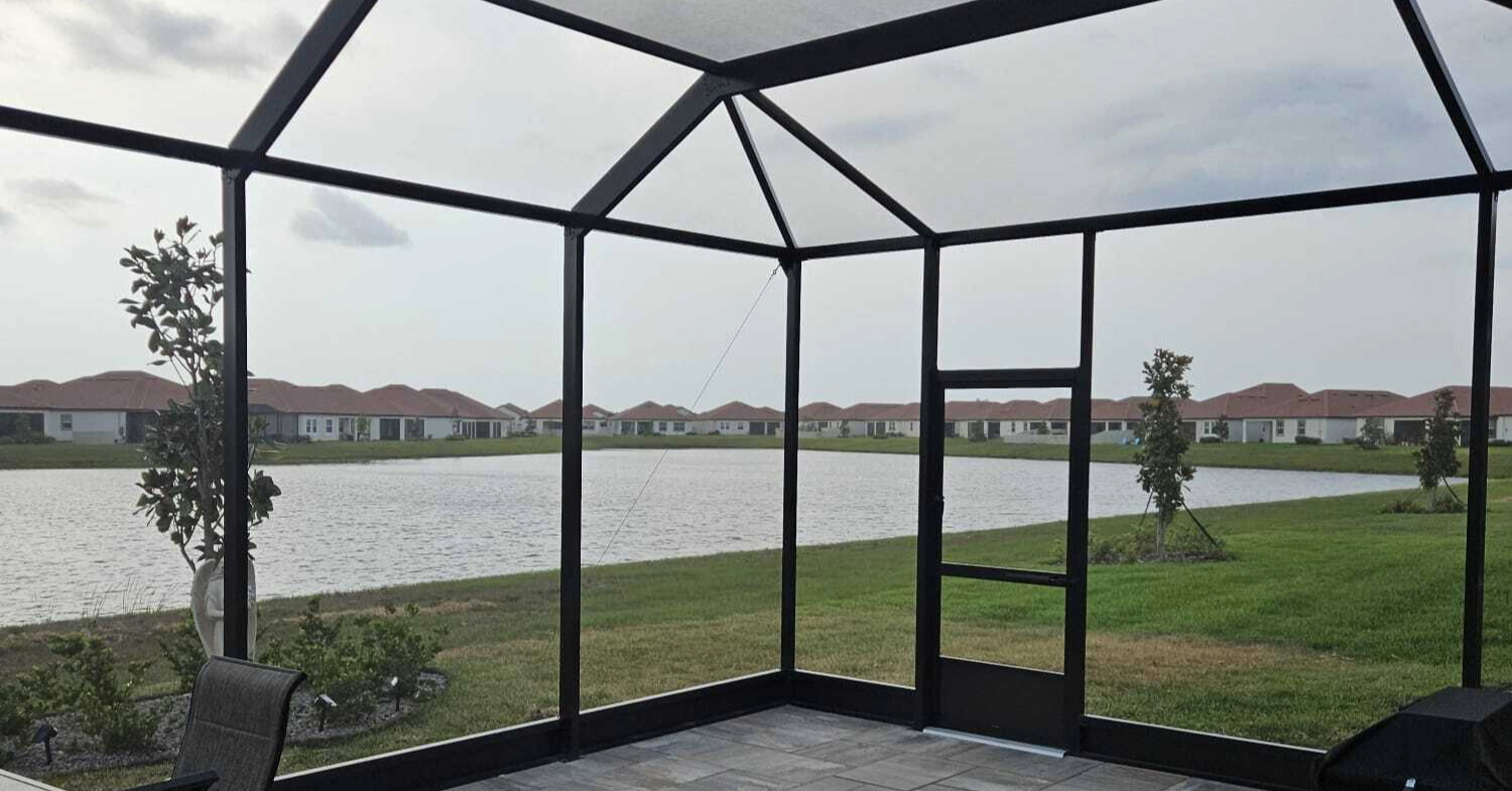 Interior view of a waterfront patio space, illustrating the value of your lanai screen enclosure cost.