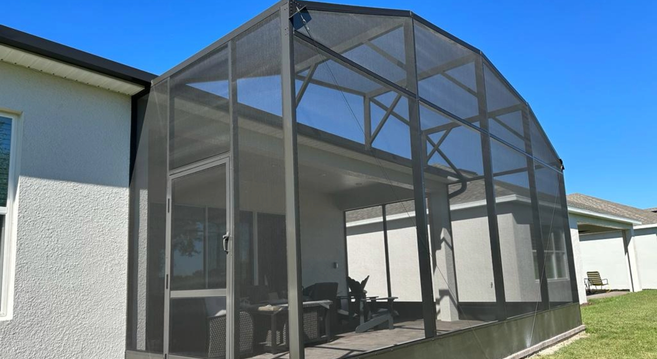 Exterior view of an aluminum frame attached to a home, showing the structural quality included in the lanai screen enclosure cost.