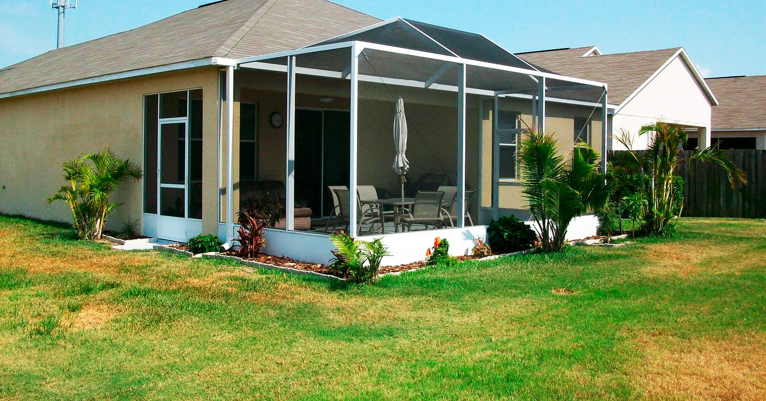 A long white aluminum screen porch enclosure illustrating typical lanai screen installation cost