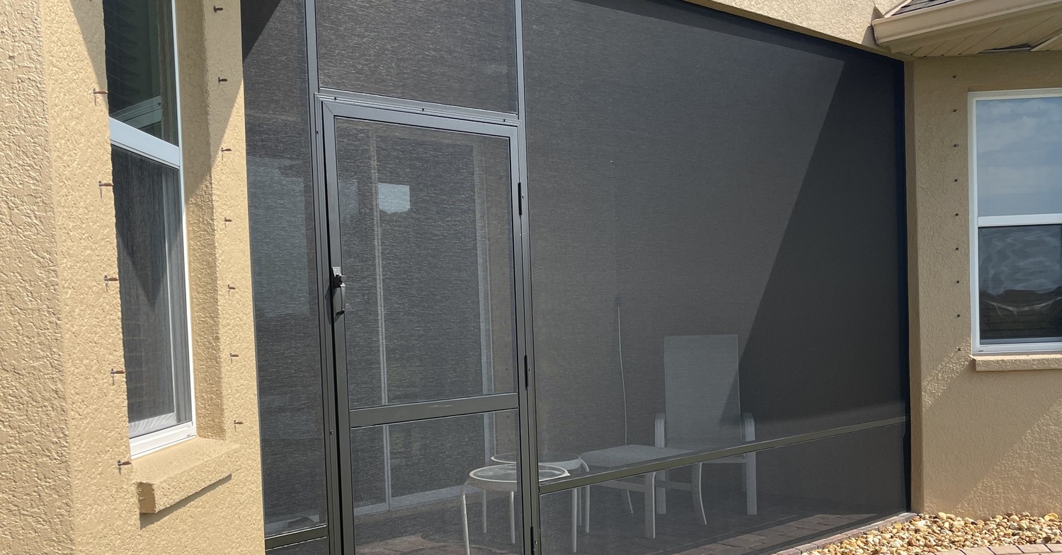 A close-up exterior view of patio doors illustrating aluminum vs fiberglass screen materials.