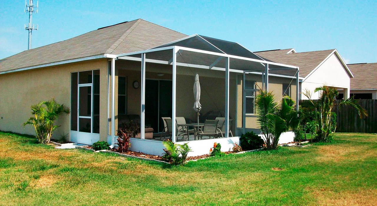 An outdoor backyard view highlighting the design differences of a lanai vs screen room.