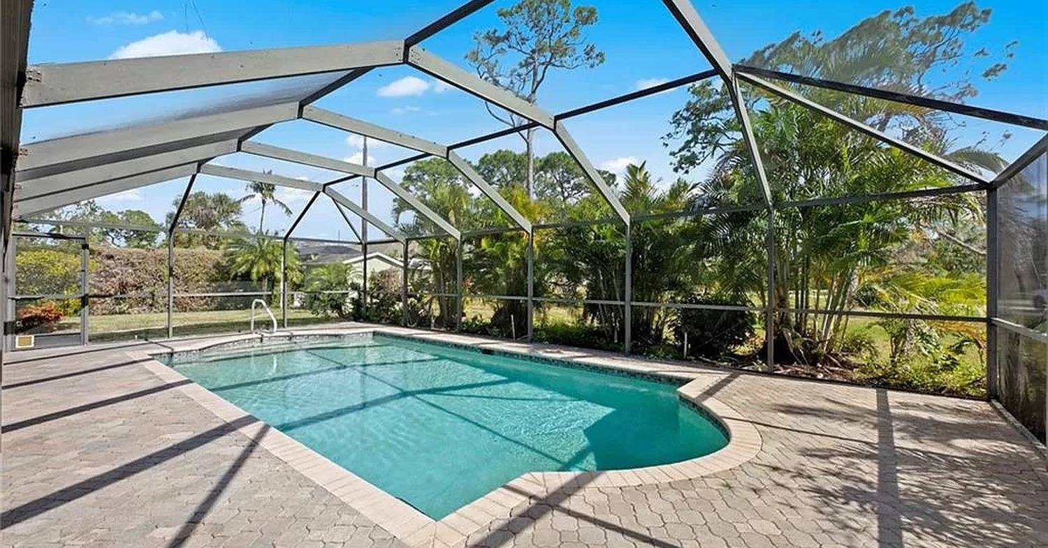 An expansive swimming pool dome structure showcasing a pool cage vs pool screen enclosure.