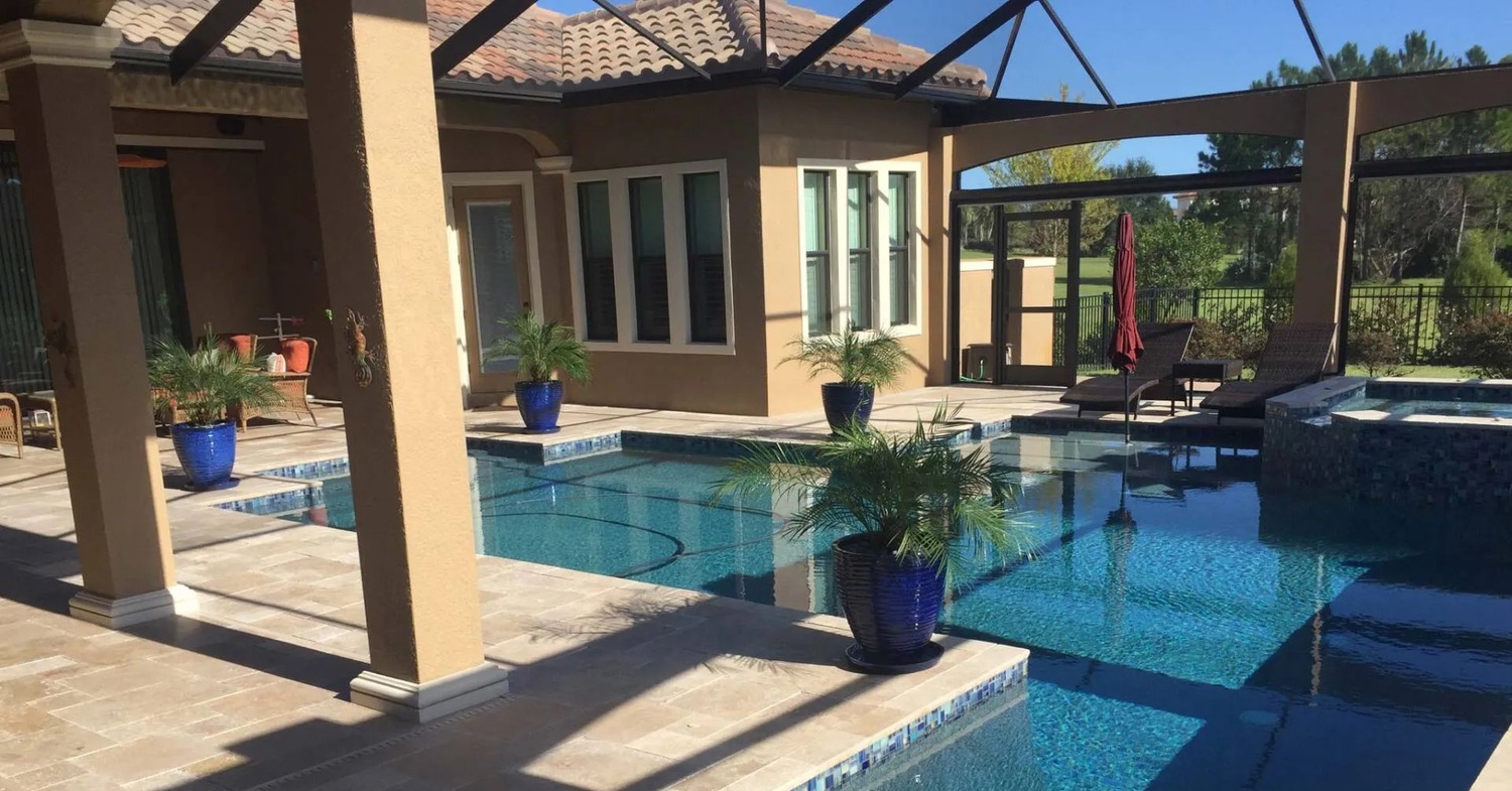 A luxurious covered poolside patio highlighting the choice of screen room vs sunroom.